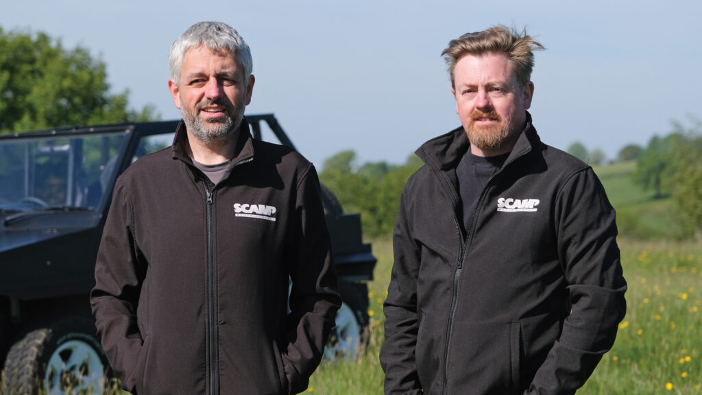 Two men beside vehicle