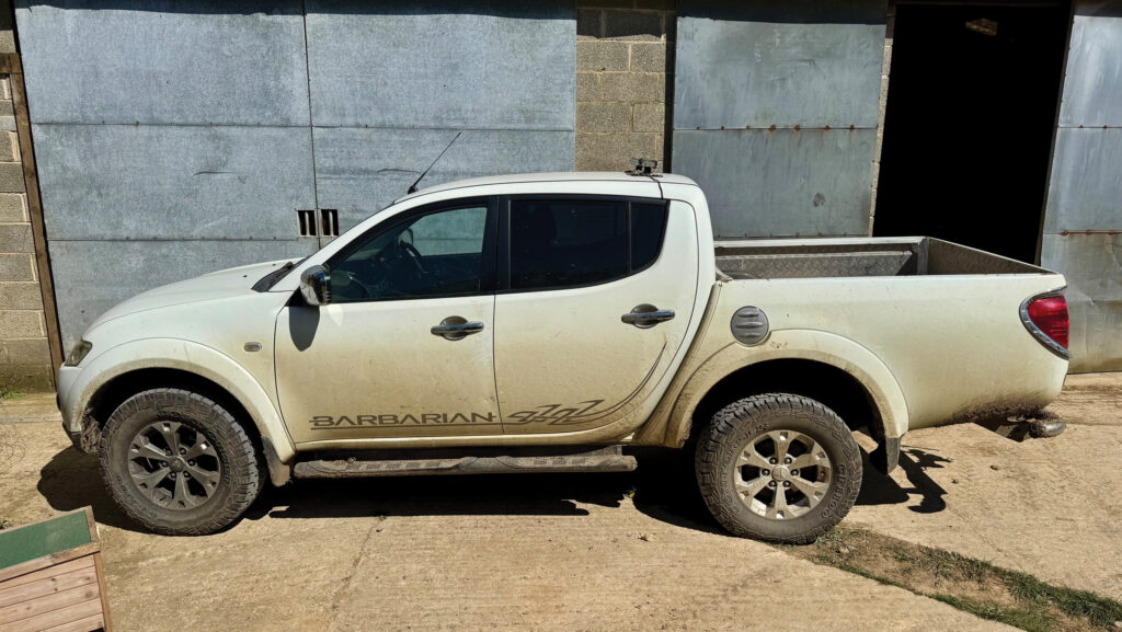 Pickup parked in a farmyard