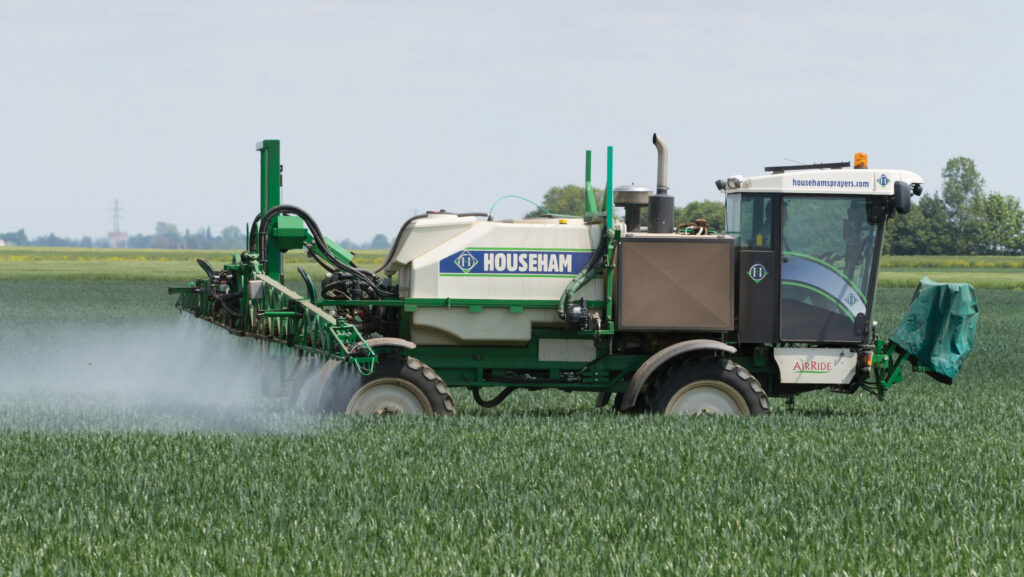 Sprayer in winter wheat crop