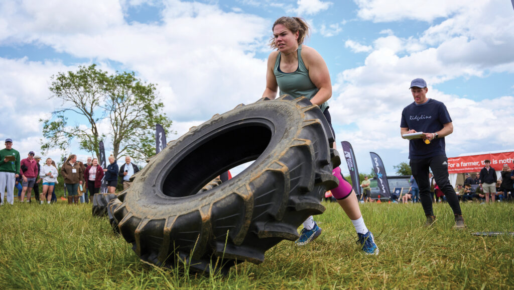 A woman pushing a tyre
