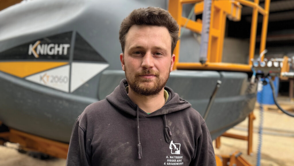 Man standing in front of sprayer