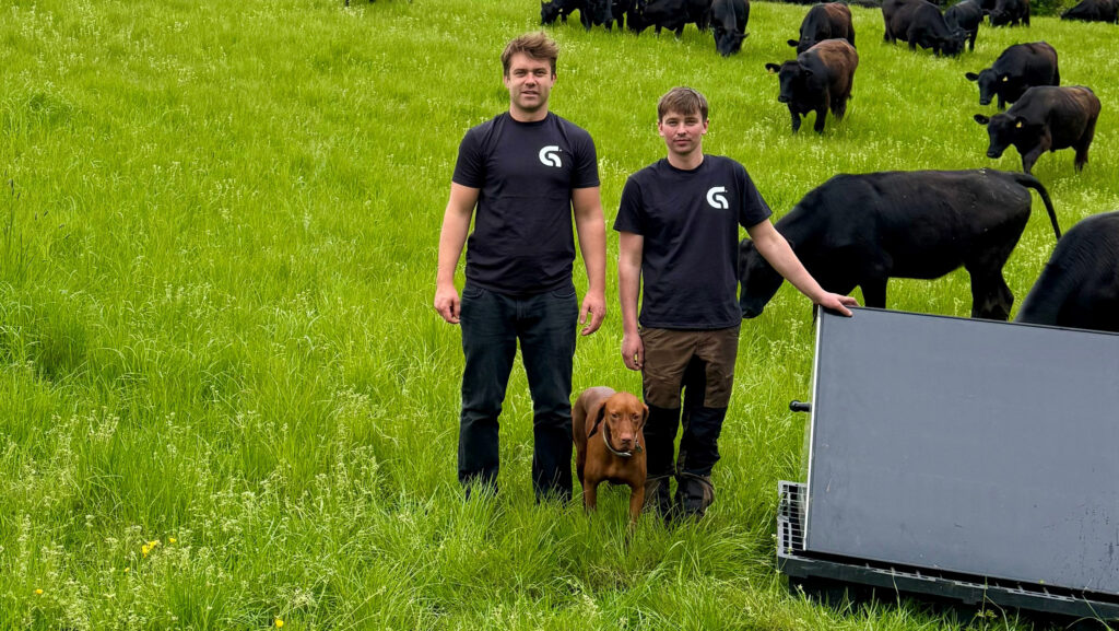 Harry and Giles Garside standing beside their solar pump