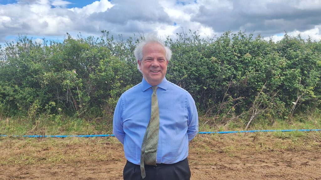 Man poses in a field