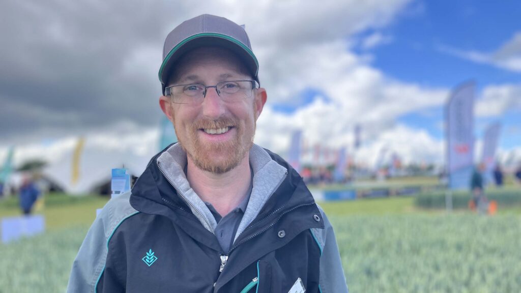 Man poses in a field