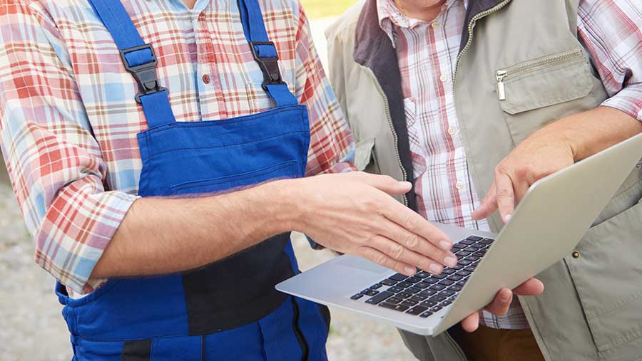 Two people looking at laptop