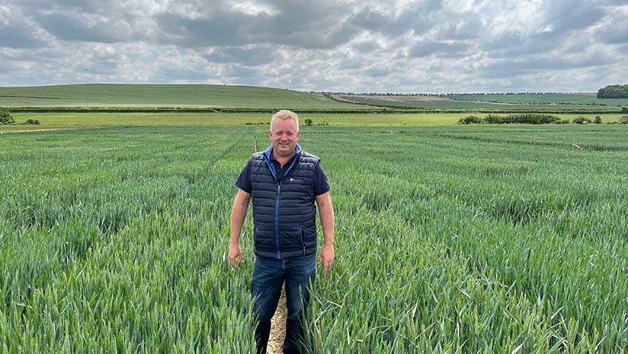 Andrew Creasy standing in field of wheat
