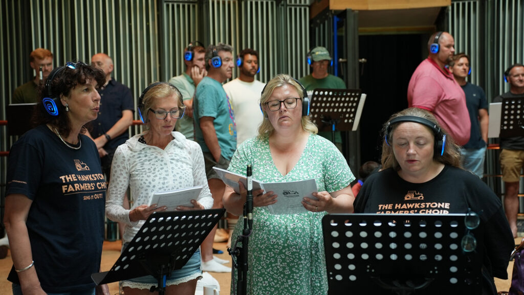 Choir members in a recording studio