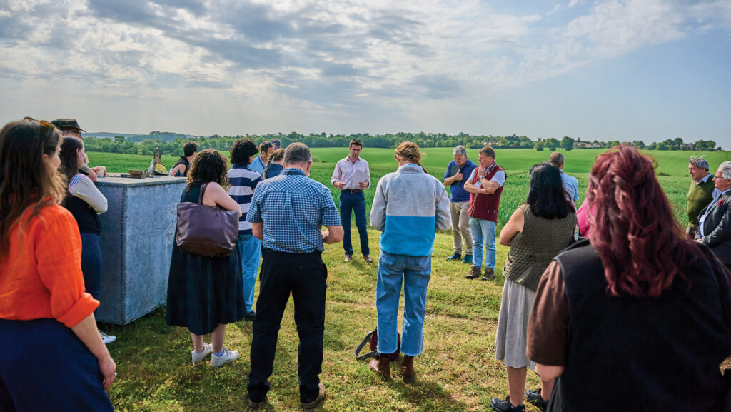Harry Reynolds explaining to a group of farmers how his farm switched to regen
