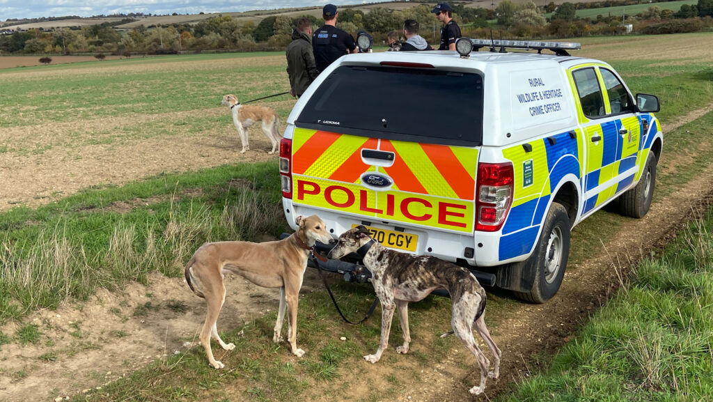 Police with a man suspected of hare coursing