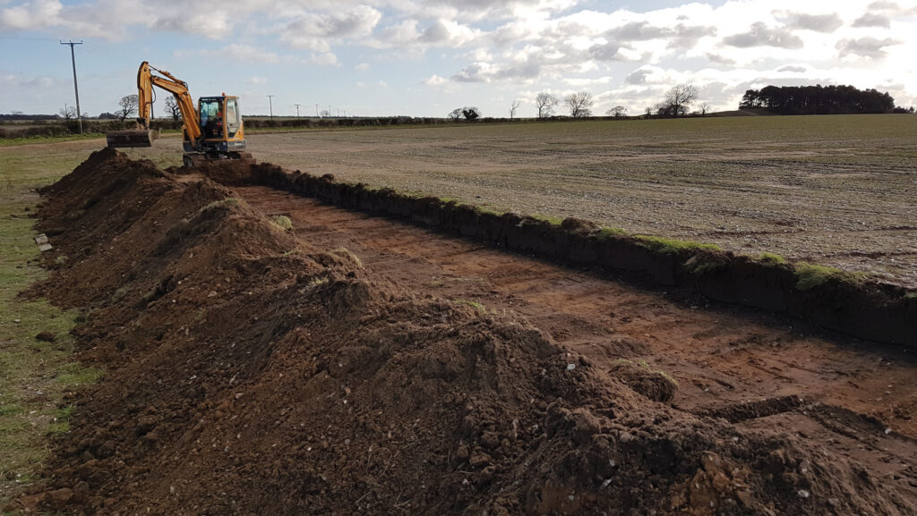 An excavator working in a field 