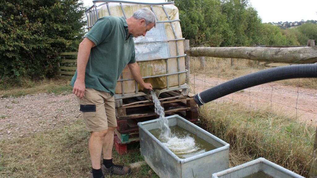 David Rendle filling the water troughs