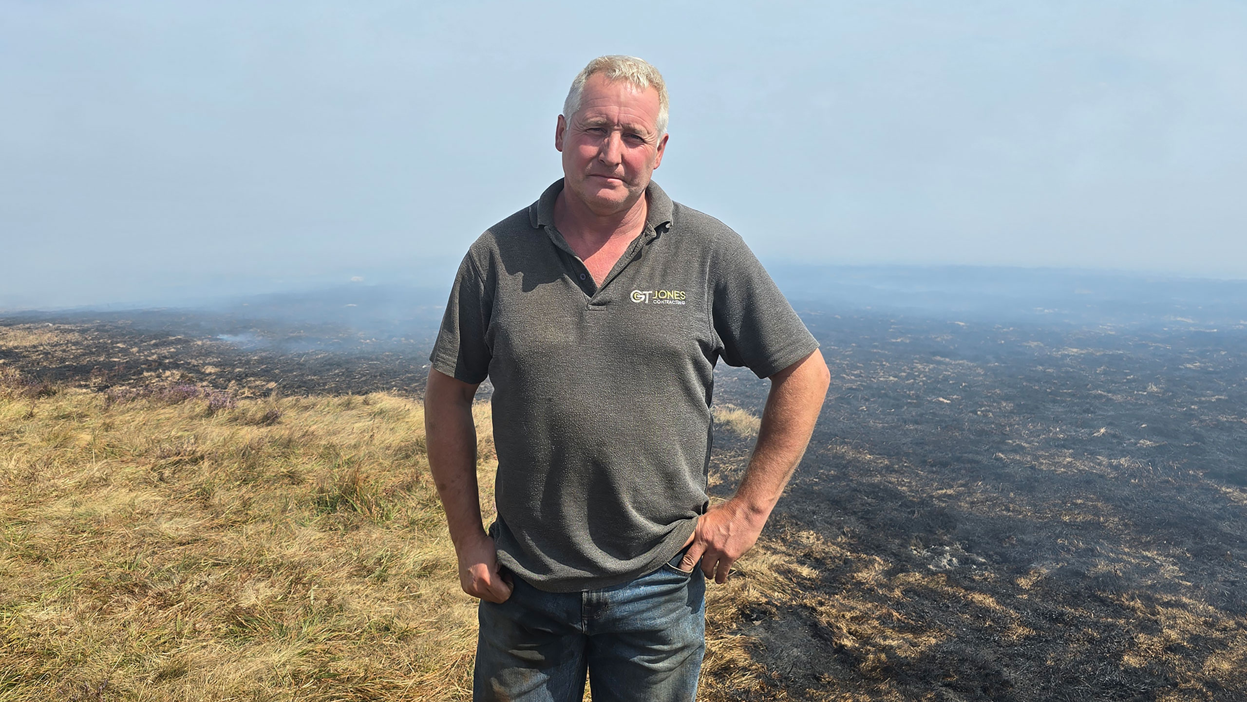 Contractor Gareth Jones with burned landscape