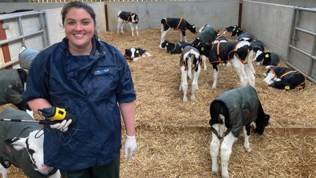 Kat Hart in a pen of young calves