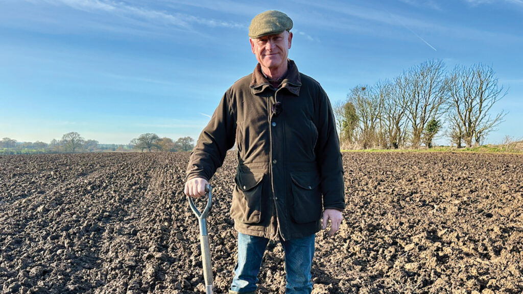 A man in a ploughed field