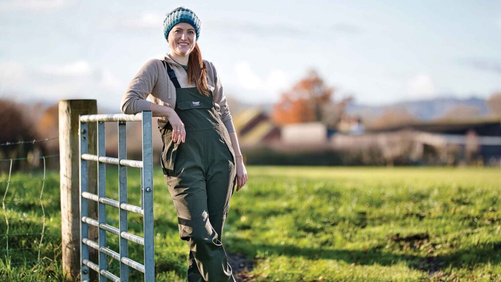 Lucy Eyre standing by field gate