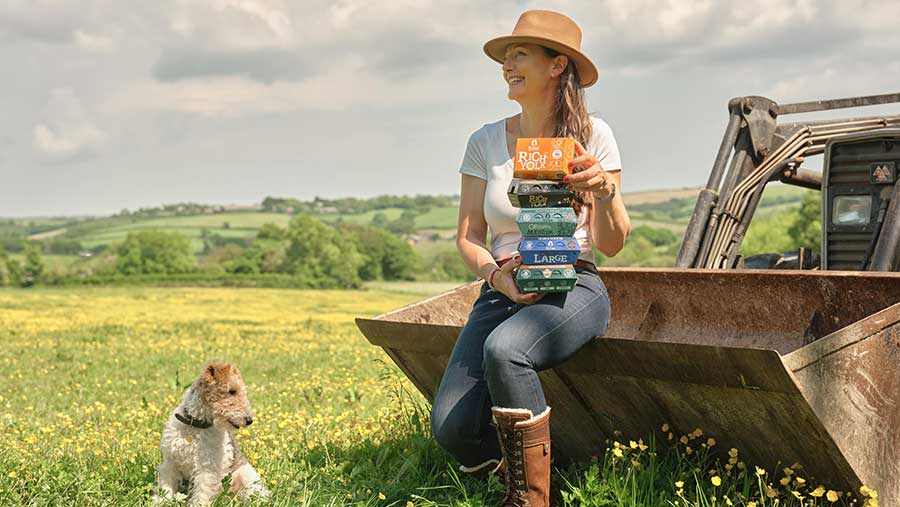St. Ewe Free Range Eggs boxes being held by woman
