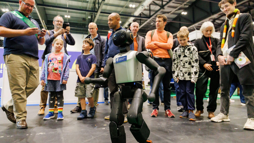 Show-goers crowd round Nigel the humanoid robot at New Scientist Live