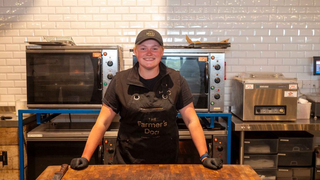 Charlotte Kingham standing behind a counter