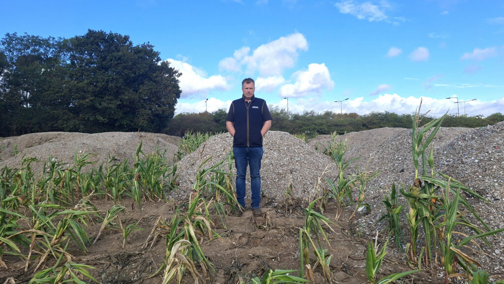 Essex farmer Alex Sell among the fly-tipped waste on his farm © NFU