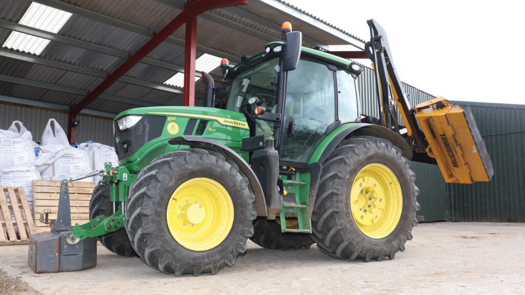 John Deere tractor and yellow hedger