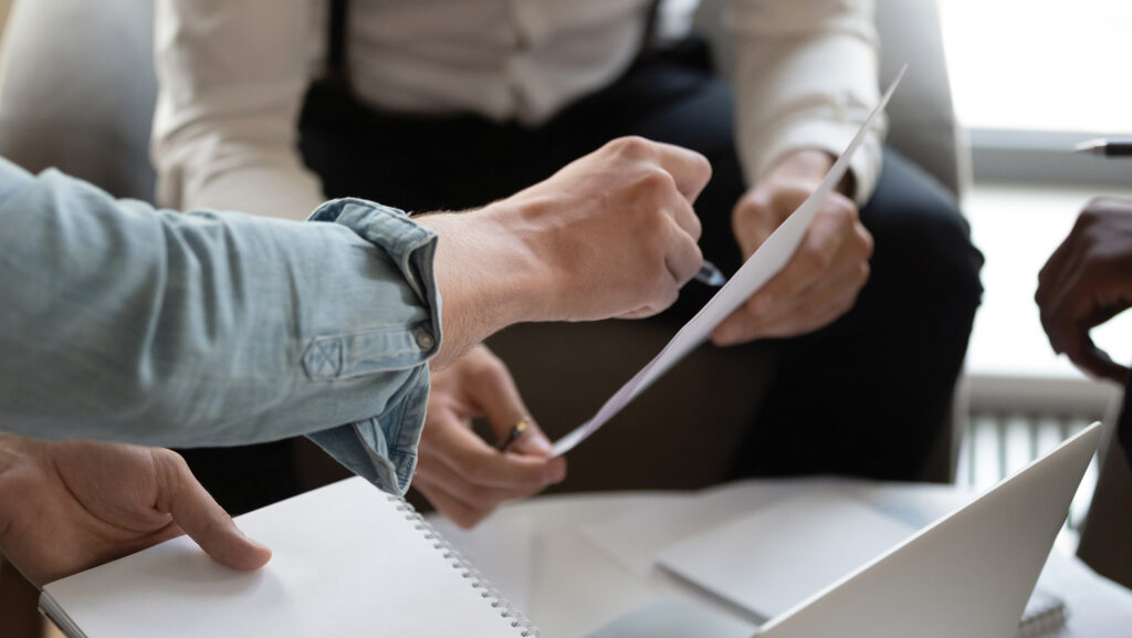 Two people discussing paperwork