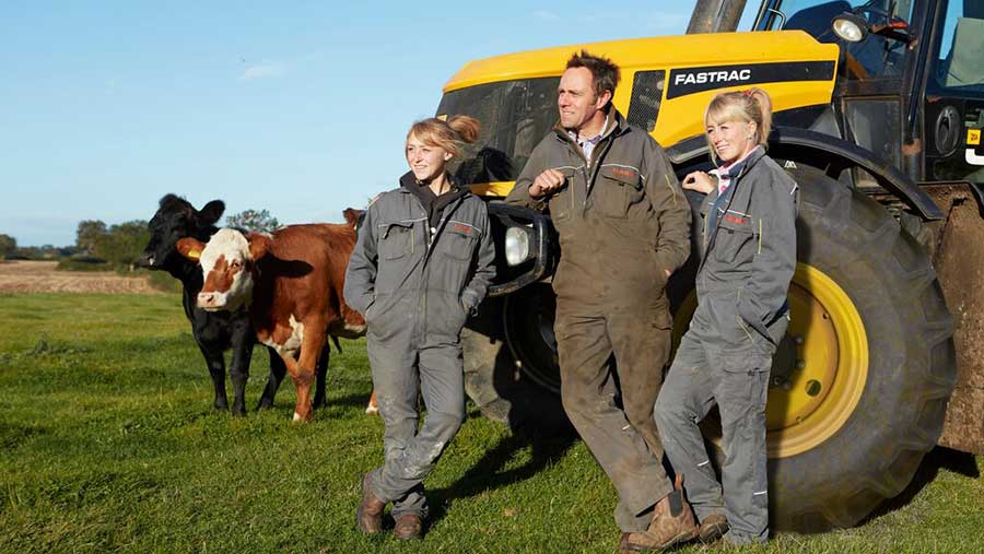 Group of people stood in front of tractor