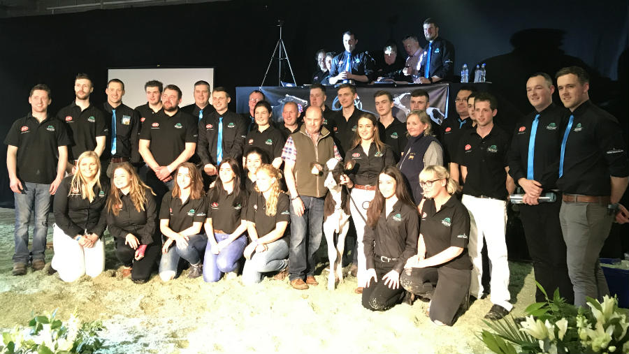 The organisers of the sales gathered in the ring with an animal.