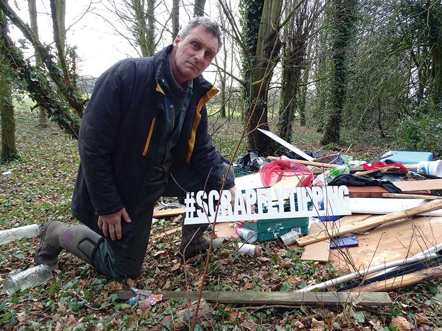 Will Dickinson with a pile of fly-tipped rubbish