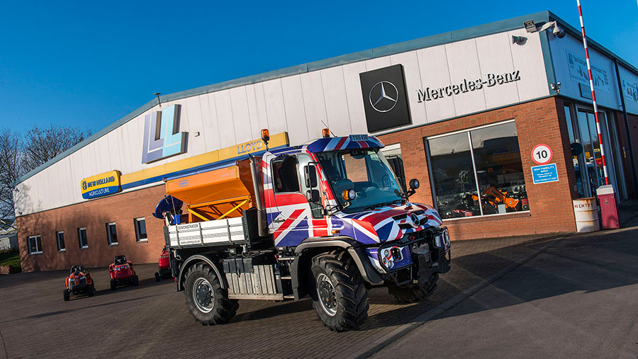A Mercedes-Benz Unimog with Union flag livery stands outside a Lloyd dealership