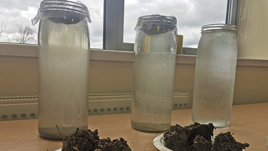 Jars of water showing different grades of discolouration