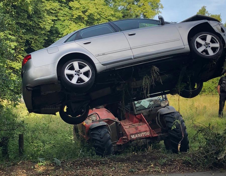 Telehandler removing Audi from field
