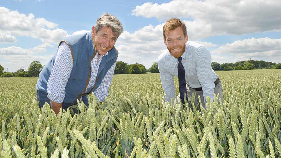 Mark Tubby and Ben Chapman stand in a field of wheat