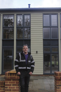 William Ashley standing outside his barn conversion