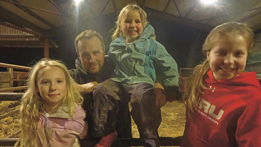 Alan Rees stands in the shed with three children