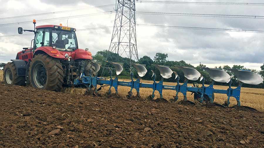 A Case IH Magnum 335 tractor with Lemken plough works in the field