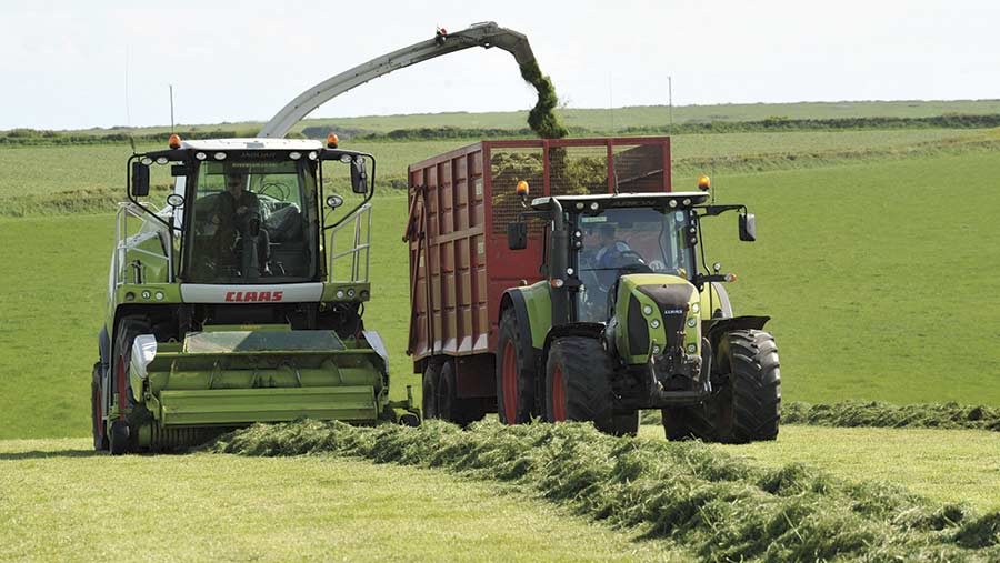 A silage trailer is filled in a field 