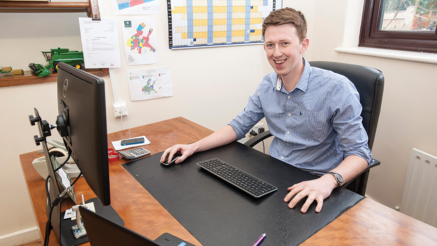 Alistair McBain behind a desk