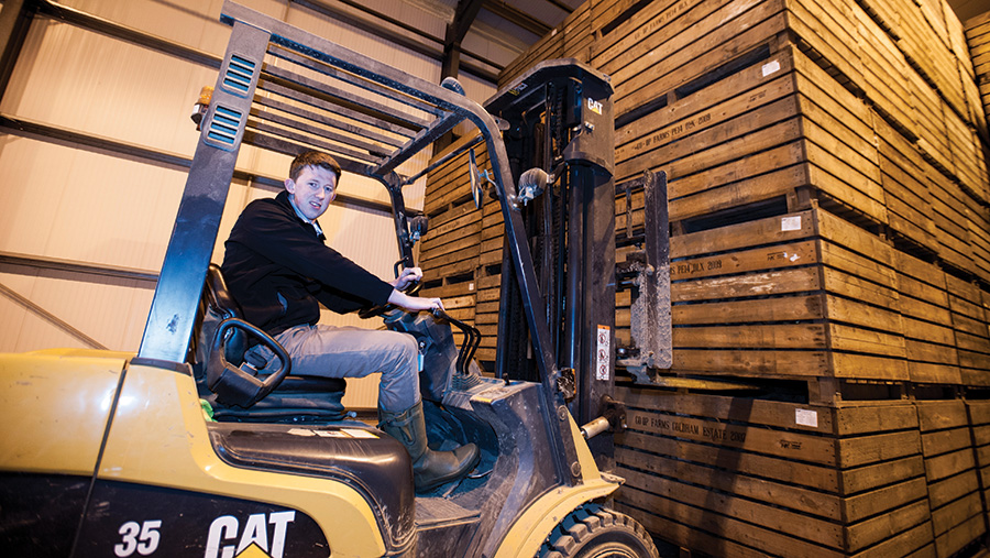 Alistair McBain with a forklift lifting a pallet