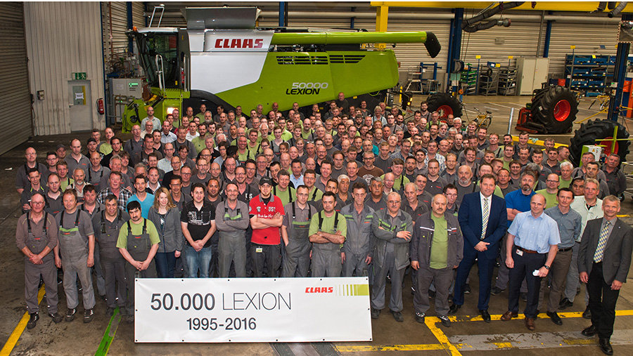 Claas workers stand in front of the 50,000th Lexion