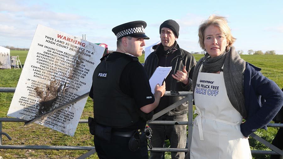 Emma Thompson speaking to a police officer
