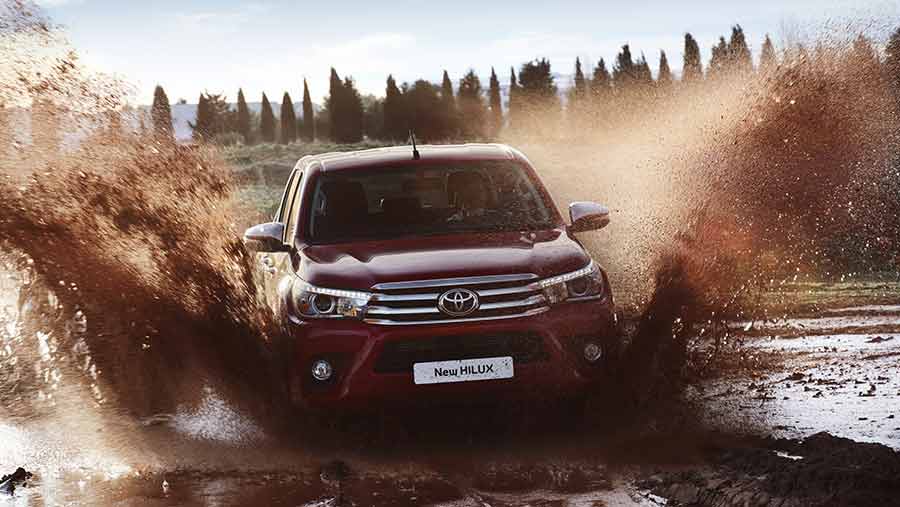 New Toyota Hilux driving through mud