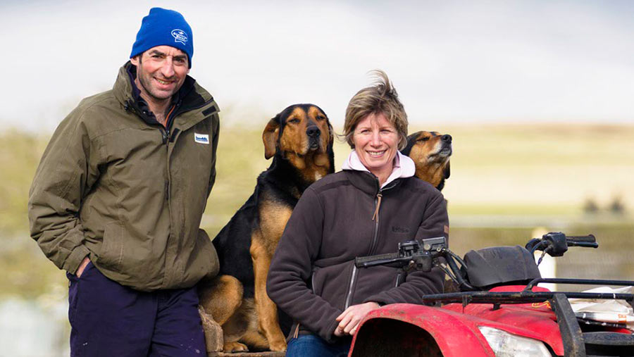 Hamish and Susie Dyke sit on an ATV  with their dogs