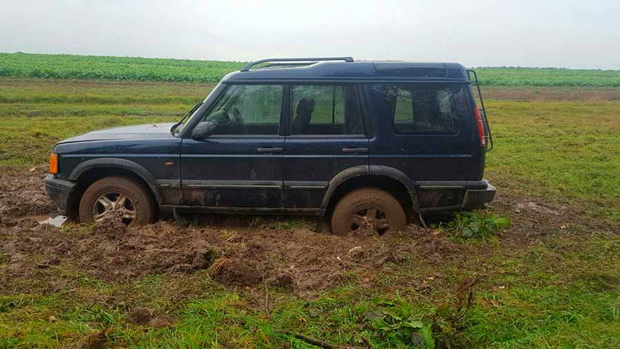 Land Rover stuck in mud in field