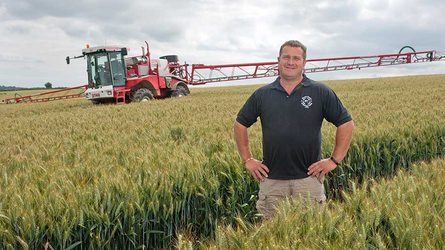 Scott Bagwell in a field with a sprayer