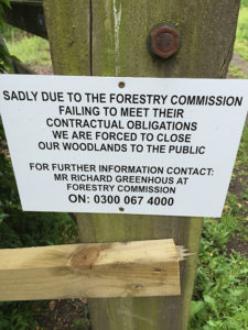 Picture of a sign reading: Sadly due to the Forestry Commission failing to meet their contractual obligations we are forced to close our woodlands to the public. For further information contact: Mr Richard Greenhouse at Forestry Commission On: 0300 067 4000