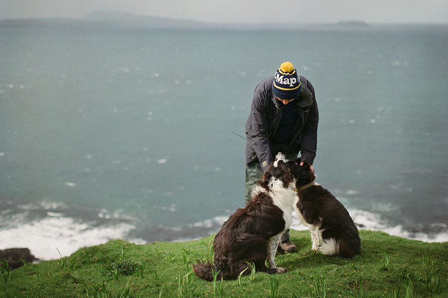 Sarah Boden with dogs by the coast