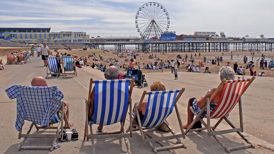 People in deck chairs on the Golden Mile © Peter Lomas/REX/Shutterstock