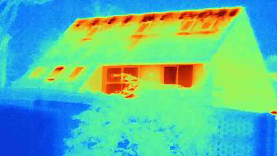 Thermal image of a house showing heat loss from roof