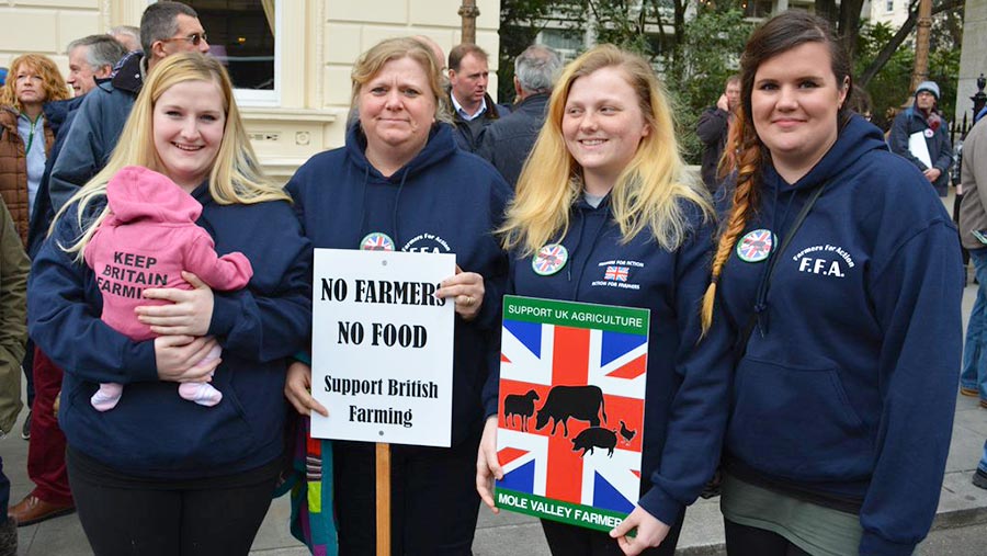 Three-farming-generations with placards---photo-Johann-Tasker