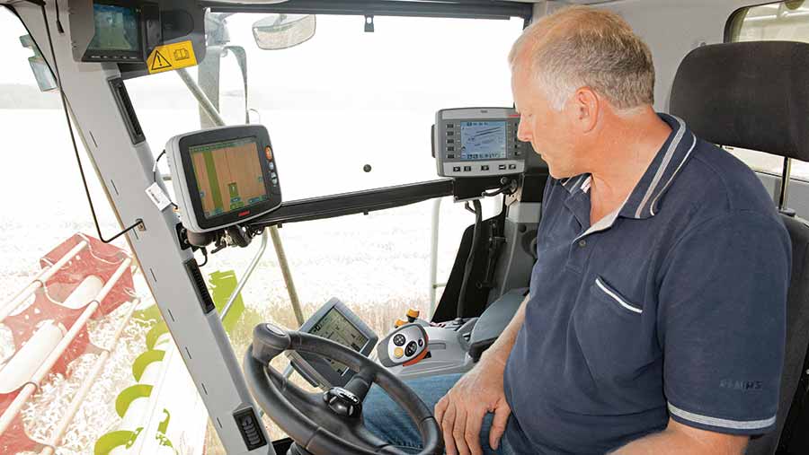 Man sitting in tractor with computer